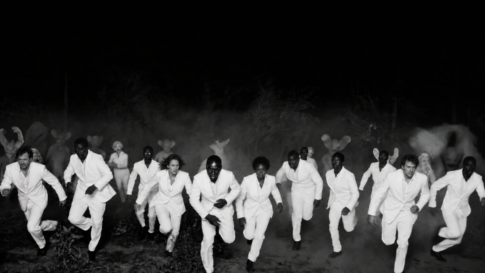 A group dressed in white runs together through the darkness.